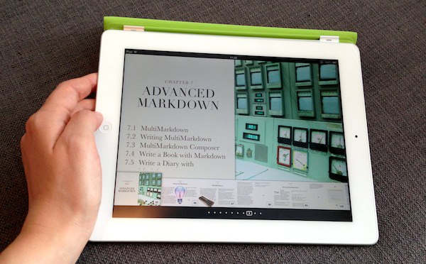 The MacSparky Markdown Field Guide eBook open on an iPad with a hand holding the tablet.
